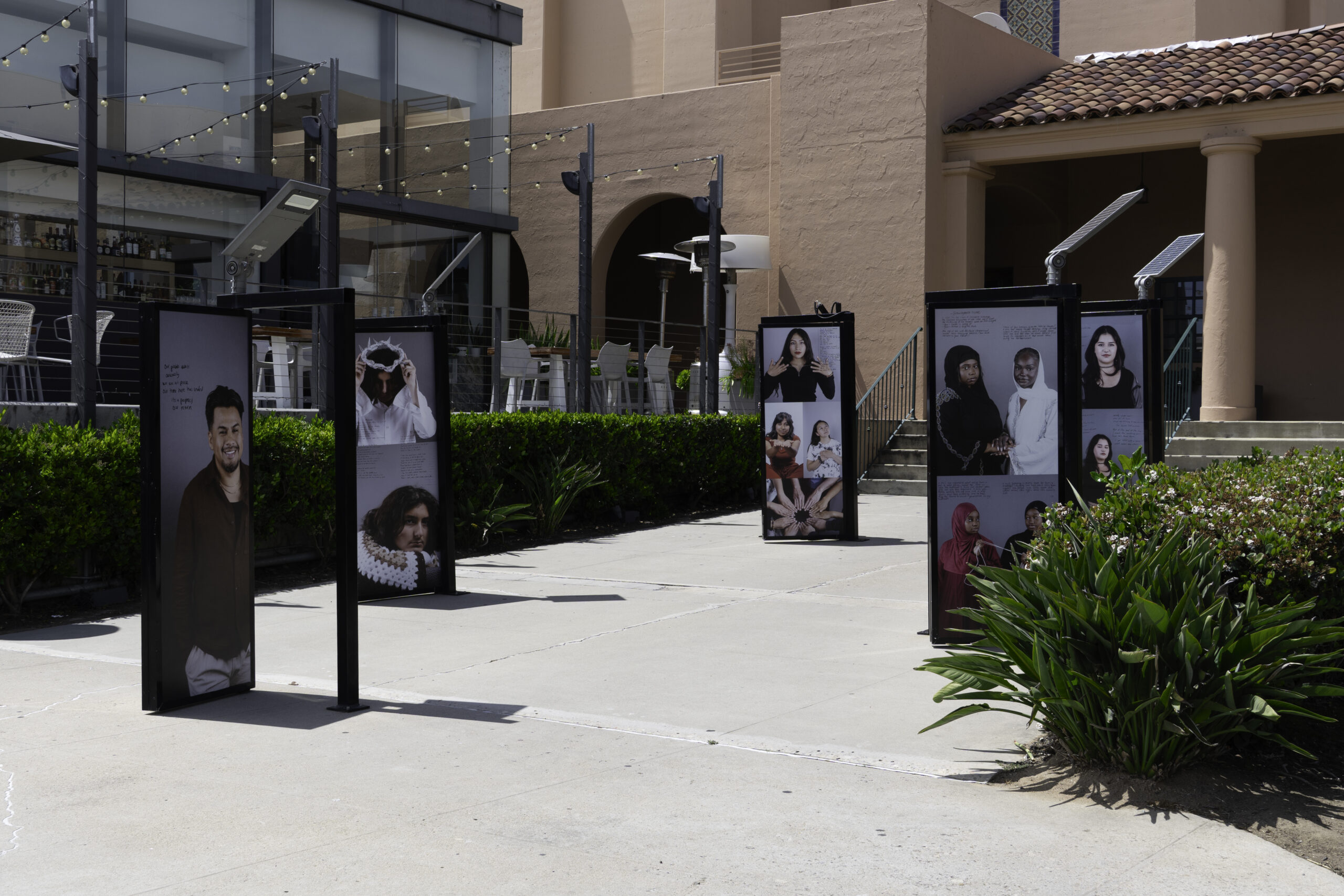 photo of art installation titled Transcending Perception which is made up of paneled doors showcasing artists and narratives. 